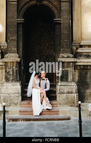 Portrait of bride sitting on steps Stock Photo - Alamy