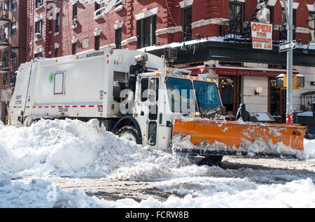 Snowplow cleaning up after a winter storm in Lower Manhattan, NYC Stock Photo