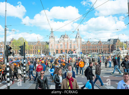 AMSTERDAM APR 27: People at the Central Station on Kings Day in Amsterdam on April 27. 2015 in the Netherlands Stock Photo