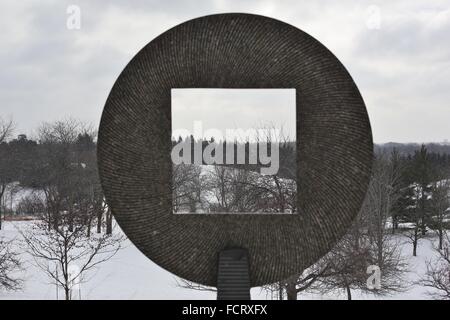 A rural, winter landscape as seen through a sculpture by Jesus Bautista Moroles at the Minnesota Landscape Arboretum. Stock Photo