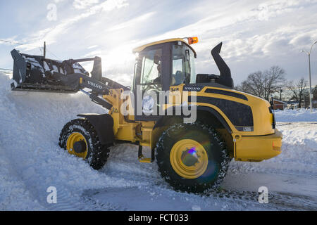 Merrick, New York, USA. 24th Jan, 2016. After Nor'easter drops more than two feet of snow on south shore of Nassau County, Long Island, many Town of Hempstead Highway Department employees work long hours operating snow ploys to plows to remove about 25 inches of snow blanketing downtown streets and public parking lots. Credit:  Ann Parry/ZUMA Wire/Alamy Live News Stock Photo