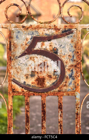Rusting Wrought Iron No 5 Sign on Metal Gate, Grunge Stock Photo