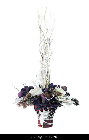 Arrangement from artificial flowers orchids, roses, Christmas balls and maple leaves in vase isolated on white background. Stock Photo