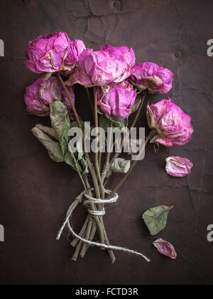 Bouquet of dry Roses on old Leather Stock Photo