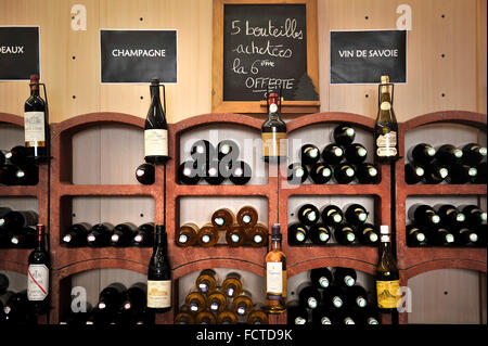 Bottles of French wine on shelves in the shop of a wine merchant. Stock Photo