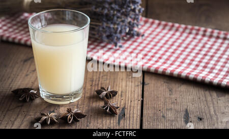 Glass with french Pastis on wooden Table Stock Photo