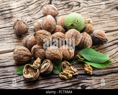 Walnuts on the wooden table. The autumn harvest. Stock Photo