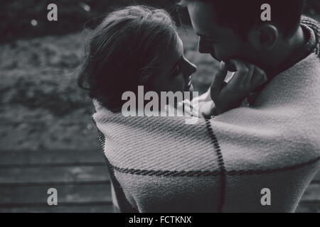 Young couple wrapped in plaid Stock Photo