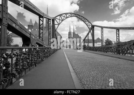 Numerous padlocks on the Tumski Bridge over the Odra river in Wroclaw leading to the Tomski island with the Cathedral Stock Photo