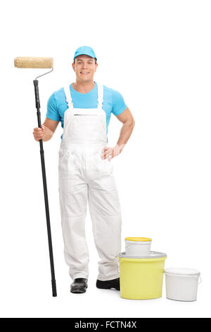Full length portrait of a young male decorator holding a paint roller and looking at the camera isolated on white background Stock Photo