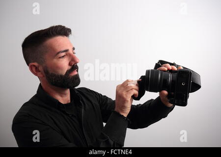Man cleaning the camera lens Stock Photo