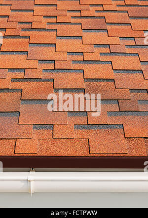 Bitumen asphalt shingles with plastic drainage on house roof. Stock Photo