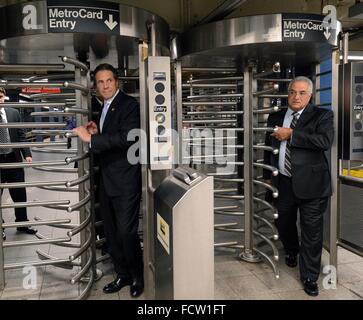 New York Governor Andrew Cuomo walks through a subway turnstile after riding the E train subway to assure New Yorkers that the transit system is safe from terrorism September 25, 2014 in New York City, New York. Stock Photo