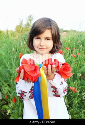 Smiling Girl Holding Wreath with Ukrainian Flag Ribbons Vertical Stock Photo