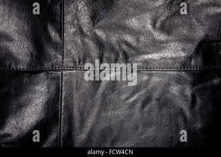 Crumpled worn leather texture with a seam Stock Photo