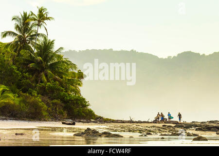 Surfers strolling on the beach at this hip southern Nicoya Peninsula surf resort; Santa Teresa, Puntarenas, Costa Rica Stock Photo