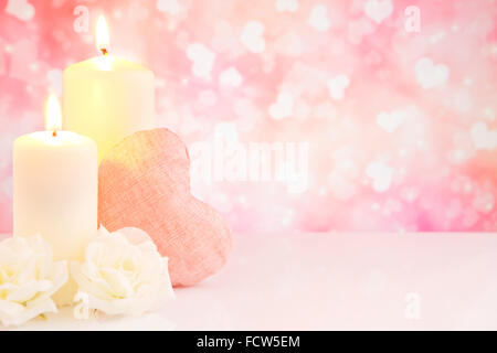 Valentine's hearts, candles and roses with a bright glittering background. Stock Photo