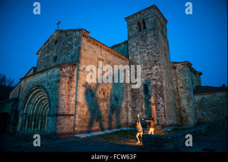 Cantabria, Spain. 24th Jan, 2016. Two girls play make shadows on the outside of the church of Santa Cruz in Castañeda (Cantabria) .monumento Romanesque twelfth century. Credit:  JOAQUIN GOMEZ SASTRE/Alamy Live News Stock Photo