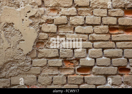 Old brick ochre painted wall. Background texture. Stock Photo