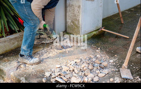 Construction site - worker using Jackhammer. Selective focus and motion blur Stock Photo