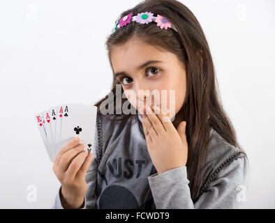 Secretive pretty young girl showing her winning poker hand Stock Photo