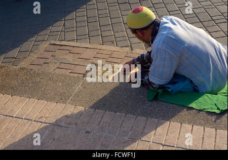 Moroccan citizen selling antiques arabic coins in Bab Chorfa market, Fez El Bali Medina. Fez, Morocco Stock Photo