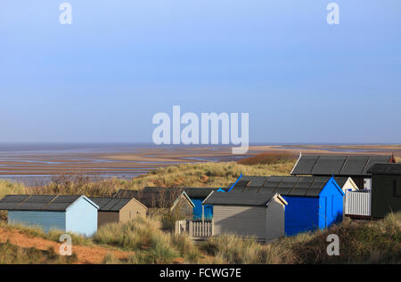 Beach huts at Old Hunstanton and the sands of the beach on the Norfolk coast. Stock Photo