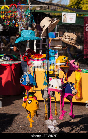 Novelty hats for sale on a rack at the fiesta San Sebastian, La Caleta, Costa Adeje, Tenerife, Canary Islands, Spain. Stock Photo