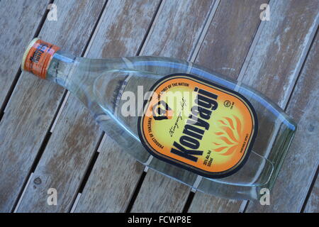 Tanzanian Konyagi, a spirit drink based on molasses made from sugarcane. The bottle is served on its side. It tastes like gin. Stock Photo