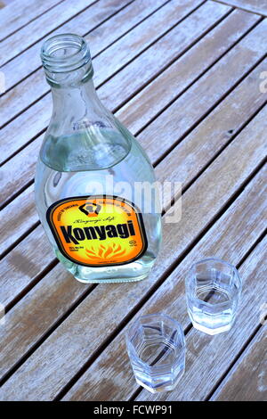 Tanzanian Konyagi, a spirit drink based on molasses made from sugarcane. The bottle is served on its side. It tastes like gin. Stock Photo