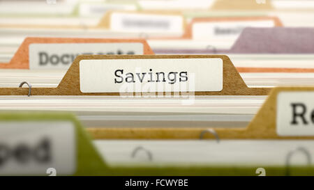 File Folder Labeled as Savings in Multicolor Archive. Closeup View. Blurred Image. Stock Photo