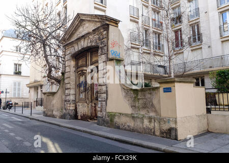 Remains of the old mansion, large arched entryway of 18th century Hotel Raoul, Paris, France. Stock Photo