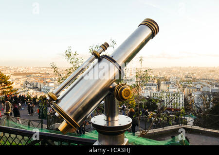 Tourists Telescope at Sacre Coeur looking out over Paris skyline, Montmartre, Paris, France Stock Photo