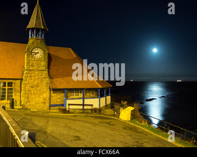 Cullercoats fisherman's lookout built in 1879 with tranquil sea reflecting full moon in the background Stock Photo