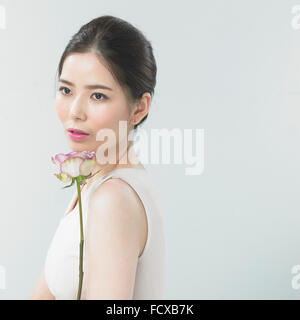 Woman with pink lip make-up with a flower Stock Photo