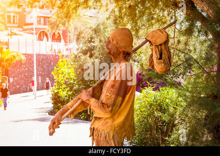 TENERIFE, SPAIN - JANUARY 14, 2013: Street performer-meme depicts a wandering poor man, Plaza Playa del Duque, Costa Adeje Stock Photo