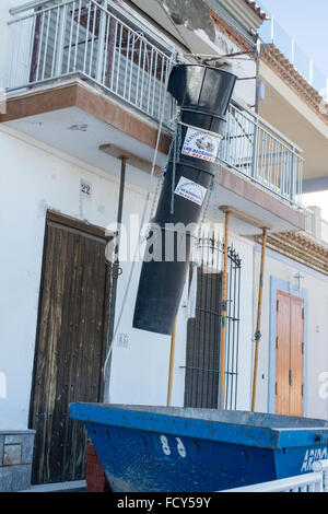 Waste shoot and skip for construction work on a property renovation at Los Alcazares, Murcia, Spain Stock Photo
