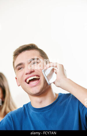 Student making a call in class with his phone at university Stock Photo