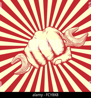 An original design of a fist holding a spanner in vintage propaganda poster wood cut style Stock Photo