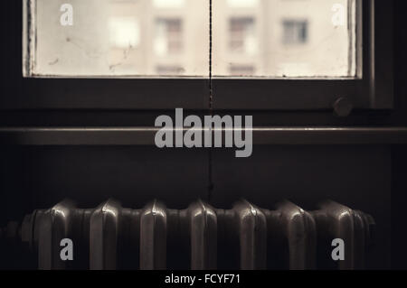 Conceptual image about heating in home, old radiator details, vintage obsolete style. Stock Photo