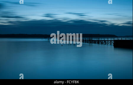 Moody shot of a wooden jetty, Poole Harbour. Stock Photo