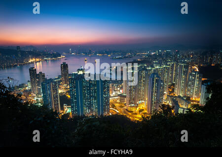 Illuminated high-rise apartment blocks in Yau Tong as seen from Devil's Peak, Kowloon Stock Photo