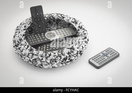 Pile of TV Remote Controls in a basket Stock Photo