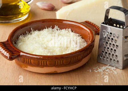 Bowl with grated Italian pecorino romano cheese, olive oil and garlic Stock Photo