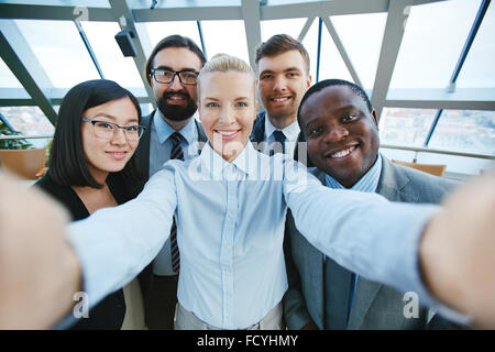 Young employees making their selfie in office Stock Photo