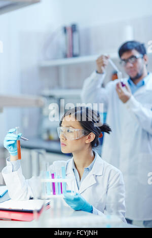 Young assistant working with substances in laboratory Stock Photo