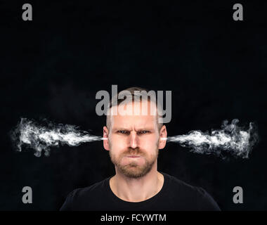 Angry man with smoke coming out from his ears. Stock Photo