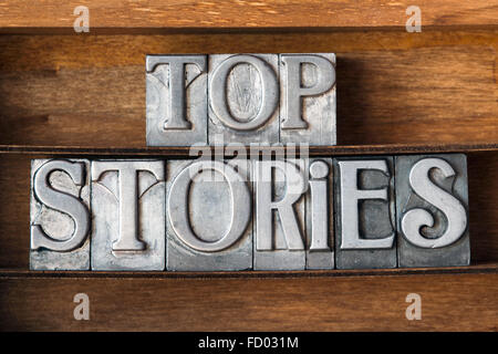 top stories phrase made from metallic letterpress type on wooden tray Stock Photo