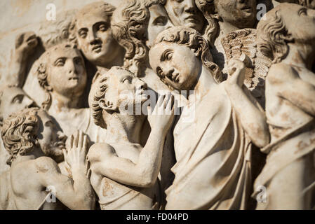 Pleading human figures from the representation of the Last Judgment on the facade of the cathedral of Orvieto in Umbria in Italy