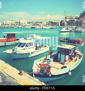 Old fishing boats and yachts in Heraklion port, Greece. Retro style filtred image Stock Photo